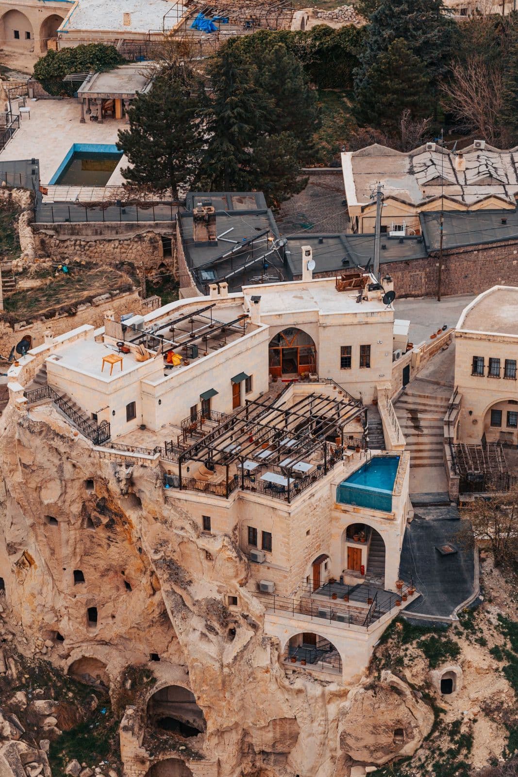 Aerial view of a cave hotel with a pool